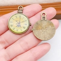 Macro view showing vintage bronze clock pendant with Eiffel Tower and floral engraving - Round Enamel Vintage Clock (17309)