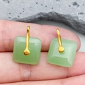 Square green faux jade earrings with golden hangers shown in hand for scale - Light Green Square Ping An Buckle (22207)
