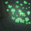 Glow in the dark unicorn and rainbow wall decals glowing in a dark bedroom setting - Green