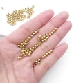 Polished golden round spacer beads for DIY jewelry making displayed in hand - Round Bead (15852)
