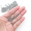 Bright silver round metal spacer beads for DIY jewelry making shown on palm - Round Bead (15857)