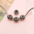 Vintage hollow silver charm bead with 3D floral relief on snake chain over pink background - Hollow Flower Style (16483)