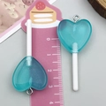Pendentif sucette cœur en résine bleu sarcelle avec paillettes argentées pour DIY - Sucette Cœur Transparent Bleu Lac (24553)
