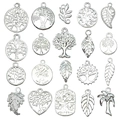 Detailed close-up of 20 silver-colored tree of life and leaf charms for DIY jewelry making - Bright Silver