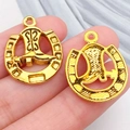 Golden horseshoe and cowboy boot charms for DIY jewelry making held on fingertips - Western Cowboy Horseshoe Boot (19241)