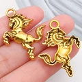 Golden horse charms for DIY jewelry making shown in hand to highlight small scale - Western Cowboy Horse (19249)