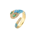 Macro shot of gold snake ring with zircon pavé head and blue enamel checkered pattern - Adjustable Open Design / Blue