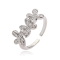 Detail of adjustable silver flower ring featuring three clover motifs with pave cubic zirconia - Platinum White Zirconia