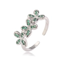 Detail view of adjustable silver ring featuring three floral charms with green zircon stones - Platinum Green Zirconia