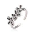 Detail of silver-tone adjustable ring featuring three black zircon-set flower patterns - Platinum Black Zirconia