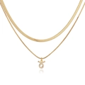 Detailed view of layered gold snake chain necklace with a crystal Taurus zodiac pendant - Gold Taurus
