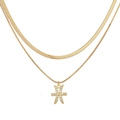 Close-up of double-layer gold necklace featuring herringbone chain and Pisces pendant - Gold Pisces