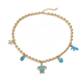 Golden beaded necklace with blue sea star and shell charms on white background - Gold Blue Enamel Necklace (Turtle)