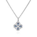Macro shot of silver clover necklace with navy blue pear-shaped stones and halo diamonds - Silver Blue Zircon Clover