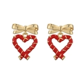 Dettaglio degli orecchini a fiocco dorato con ciondoli a cuore rossi e spirali bianche - Oro Nodo di Bambù Rosso Cuore