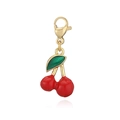 Macro shot of a red cherry pendant with green leaf and golden lobster clasp - Gold Green Leaf Red Cherry Lobster Clasp Pendant