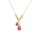 Detailed macro view of cherry necklace with red enamel hearts and clear zircon inlay - Gold Green Leaf Red Cherry Heart Bead Necklace