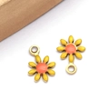 Macro shot of two yellow enamel daisy pendants for DIY jewelry with gold-plated finish - Yellow (Gold)