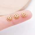 Golden hollow floral bead caps spacers for DIY jewelry making on a finger tip - 7mm / Gold