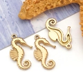 Detailed close-up of three golden seahorse charms for DIY jewelry with ocean starfish - Small Seahorse (T3039)