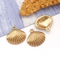 Detailed macro of golden shell pendants with textured finish and secure top rings - Small Shell (T3040)
