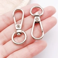 Pair of silver zinc alloy lobster swivel clasps for DIY keychains and bags held by hand - White K Flat Clasp Keychain (16x48mm-13019)