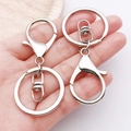 Polished silver alloy swivel lobster clasp with flat round key ring held in hand - White K Keychain Set of 3 (35x65mm-9203)