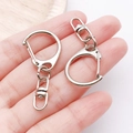 Polished silver alloy teardrop keychain hooks held in hand for size reference - White K Small C-Clasp Keychain (37X17.6mm-18769)
