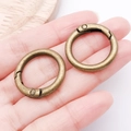Set of two vintage bronze alloy spring rings for bags shown on a hand for scale - 25mm / Antique Bronze
