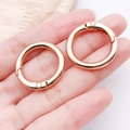 Rose gold round spring O-rings metal buckle clasps for handbags shown in palm - 25mm / KC Gold