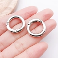 Set of two silver round spring rings held on a finger to show size for bag strap repairs - 20mm / White Gold