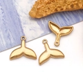 Detailed close-up of golden mermaid tail pendants on a blue ocean coral background - Small Fish Tail (T3036)