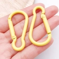 Pair of bright yellow aluminum gourd-shaped carabiners with a smooth matte finish - Yellow (26202)
