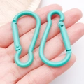 Teal green gourd-shaped aluminum carabiner clip held by hand for scale display - Dark Green (26203)