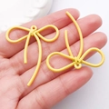 Coppia di ciondoli a fiocco giallo brillante con trama a spirale per creazione di gioielli - Giallo