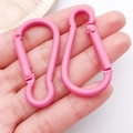 Set of two pink gourd-shaped aluminum carabiners held by hand for scale display - Rose Red (26209)
