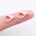 Pink matte finish lobster claw clasps for jewelry DIY projects shown on finger - Pink (14x8mm)