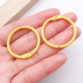 Pair of 30mm yellow matte metal binder rings held by hand for DIY jewelry and keys - Yellow