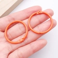 Pair of orange 30mm painted metal hinge rings with non-slip texture for DIY crafts - Orange