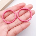 Two 30mm matte pink metal hinged rings for keychains and DIY crafts held in hand - Rose Red