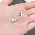 Detailed macro view of vintage silver swallow charms held in hand for size scaling - Bird (3334)