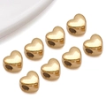 Close-up of golden heart-shaped spacer beads with polished mirror finish for DIY bracelets - Small-Medium Curved Heart Style (T3011)