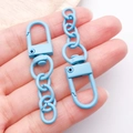 Sky blue matte zinc alloy lobster clasp with chain connector held in palm - Lake Blue