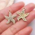 Detail of gold starfish charms featuring pave-set rhinestones and hammered metal texture - Gold Rhinestone Starfish / 22x19mm