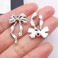 Ciondoli a fiocco in lega d'argento per creazione di gioielli fai da te e braccialetti - 30x18mm / Fiocco Argento Antico (26995)