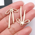 Ciondoli a fiocco cavo in oro chiaro per collane e bracciali fai-da-te - 32x19mm / Fiocco Cavo (22864)
