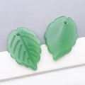 Detail view of green frosted glass leaf pendants with veins for DIY necklace making - Jelly Dark Green (26904)