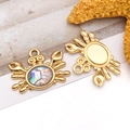 Detailed macro view of golden crab pendants with colorful abalone shell and sea star decor - Shell Crab Style (T2530)