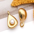 Detailed macro view of golden stainless steel teardrop charms with inlaid white pearls - Pearl Irregular Waterdrop Style (T2534)
