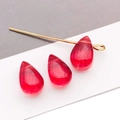 Macro detail of red teardrop glass beads and golden pin for DIY jewelry making - Transparent Red Style